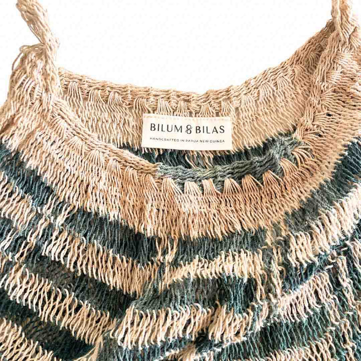 Opening close up on a blue and white natural fibre bilum bag.