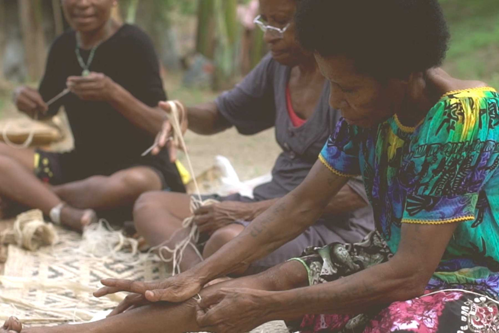 Close up of Bilum and BIlas weavers making bilums