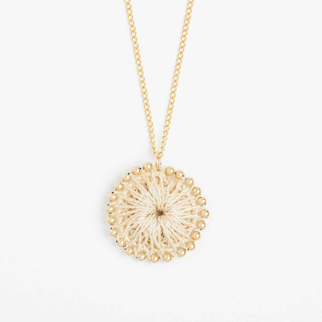 Close up on handwoven natural fibre pendant with gold filled beading. #Gold