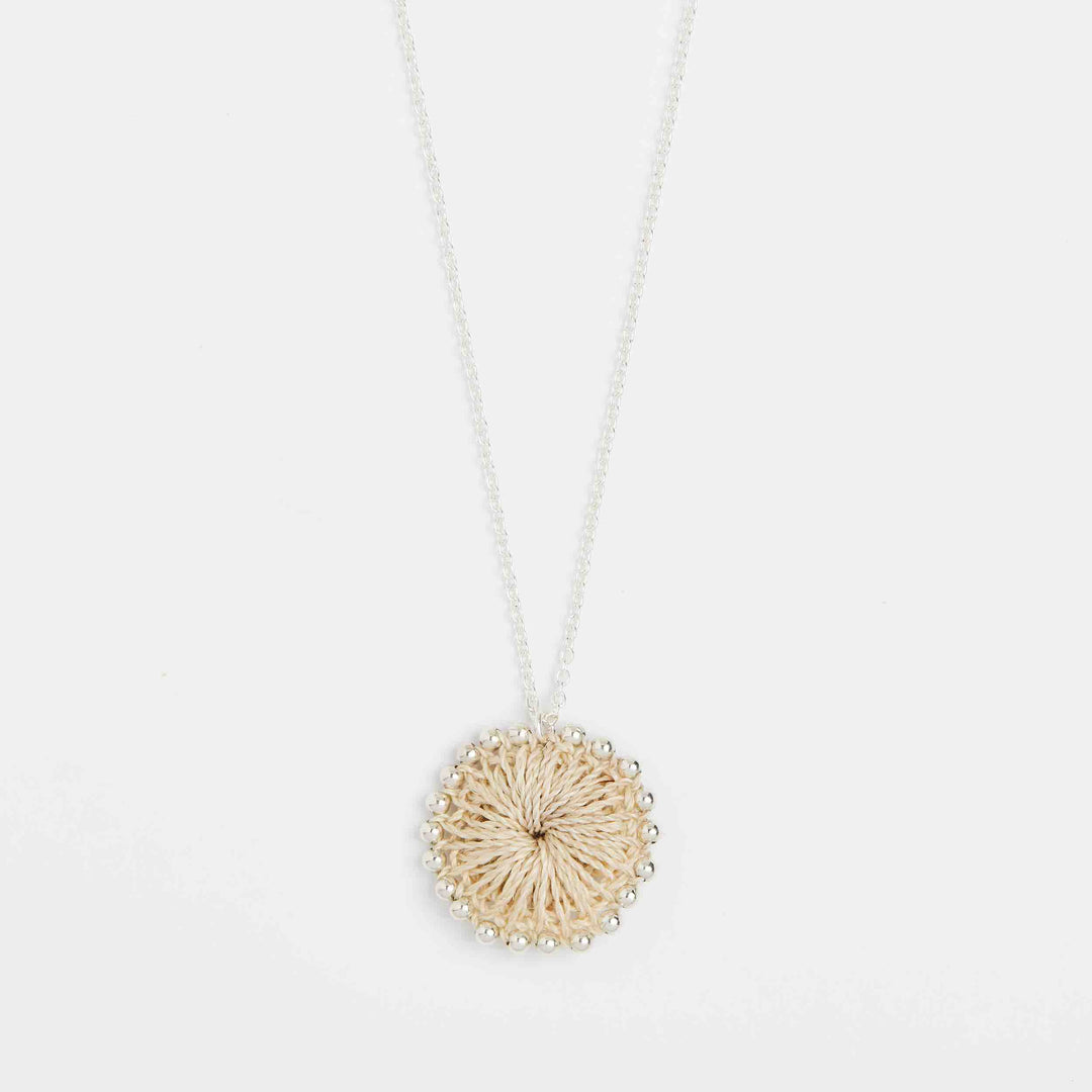 Close up on pendant of handwoven pendant disc with silver beading #Silver