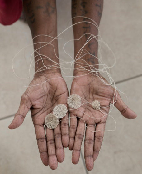 Bilum and Bilas artisans showing signature handwoven discs created for the jewellery collection