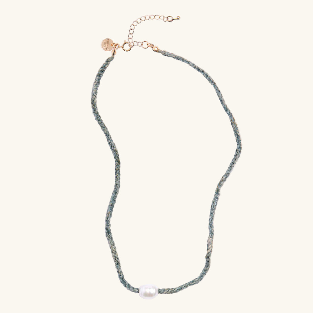 Necklace with a pearl pendant on a white background