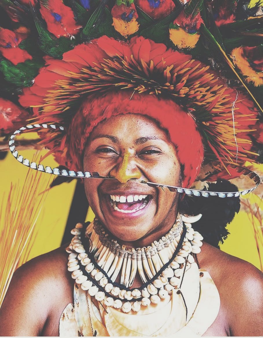 Smiling Papua New Guinean woman in full cultural dress called bilas by David Kirkland