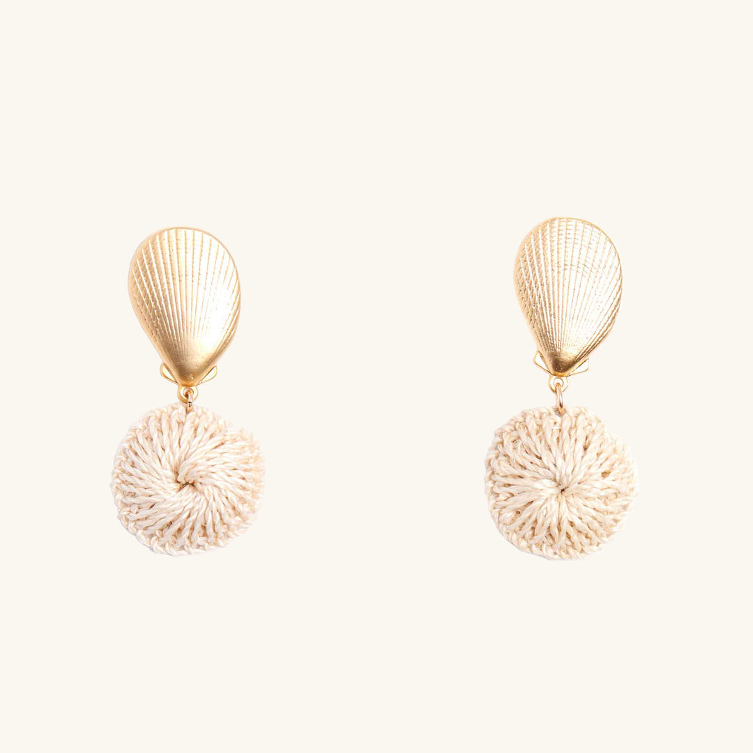 Gold shell and beige textured round earrings on a white background