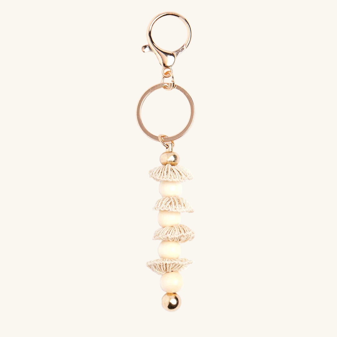 Gold keychain with decorative elements on a white background