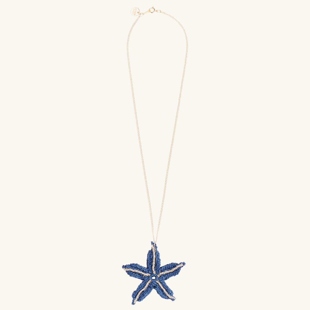 Starfish-shaped pendant necklace on a white background
