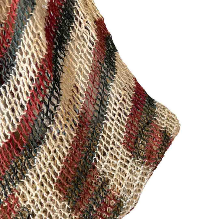 Corner of traditional brown and green tone string bilum bag from Moment Village in Papua New Guinea hanging.
