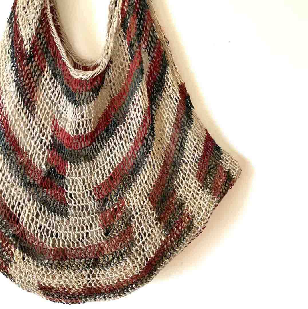 Close up on traditional brown and green tone string bilum bag from Moment Village in Papua New Guinea hanging.