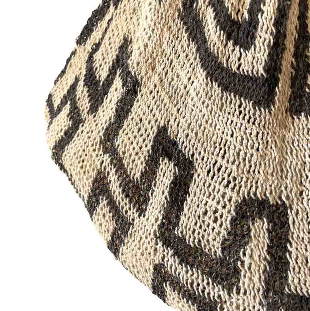 Close up on bottom of black and white patterned natural fibre string bilum bag from Papua New Guinea.