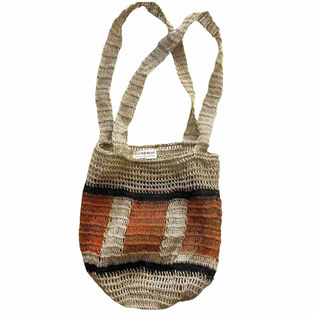 Flat lay image of double strap bucket bilum in earth tones hanging.