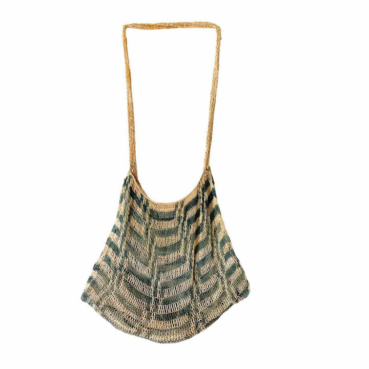 Green and white patterned natural fibre bilum hanging up.