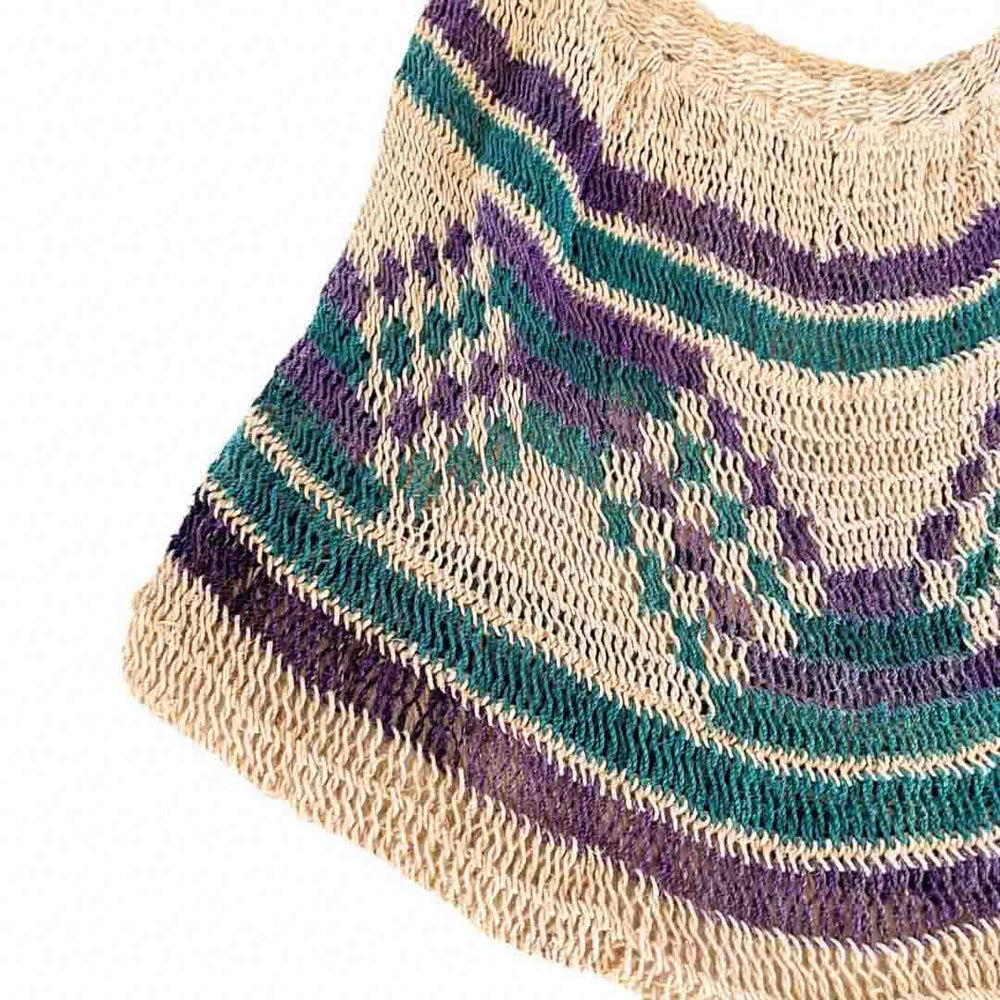 Corner close up of green and purple pattern natural fibre bilum.