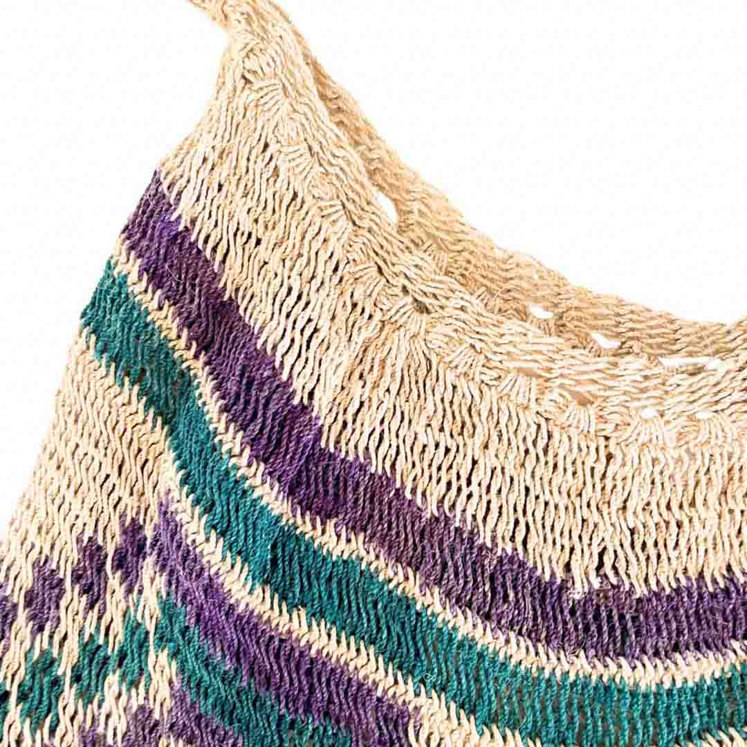 Opening close up of green and purple pattern natural fibre bilum.