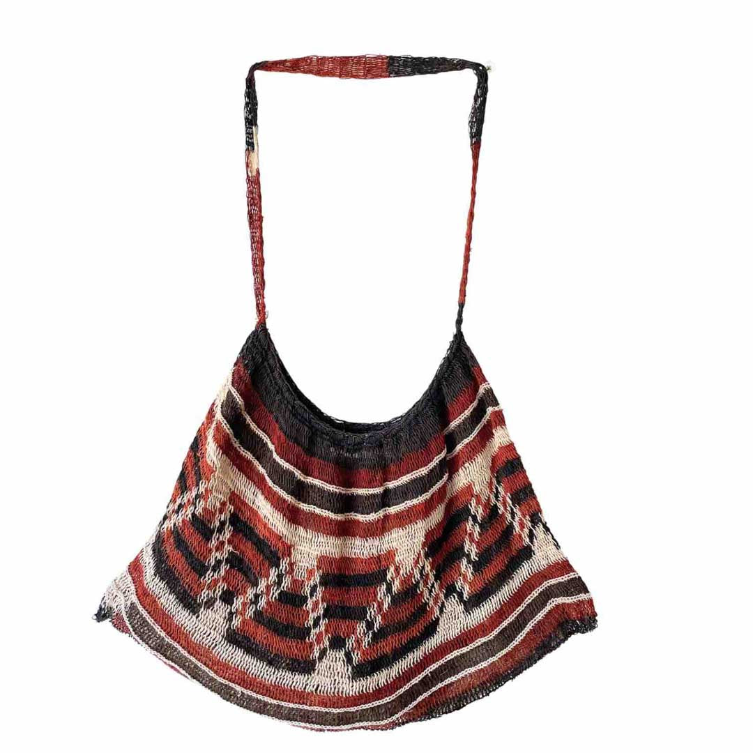Dark toned pattern natural bilum hanging on white background.