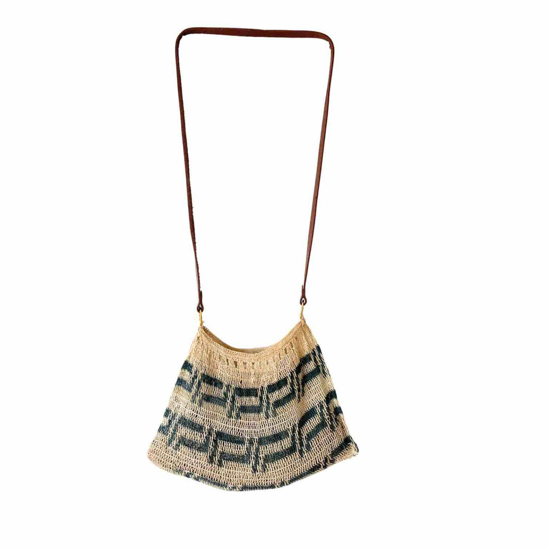 Blue and white leather strap bilum hanging on white background.