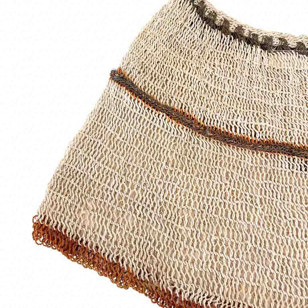 Close up on the weave of a striped natural fibre bilum with leather strap.