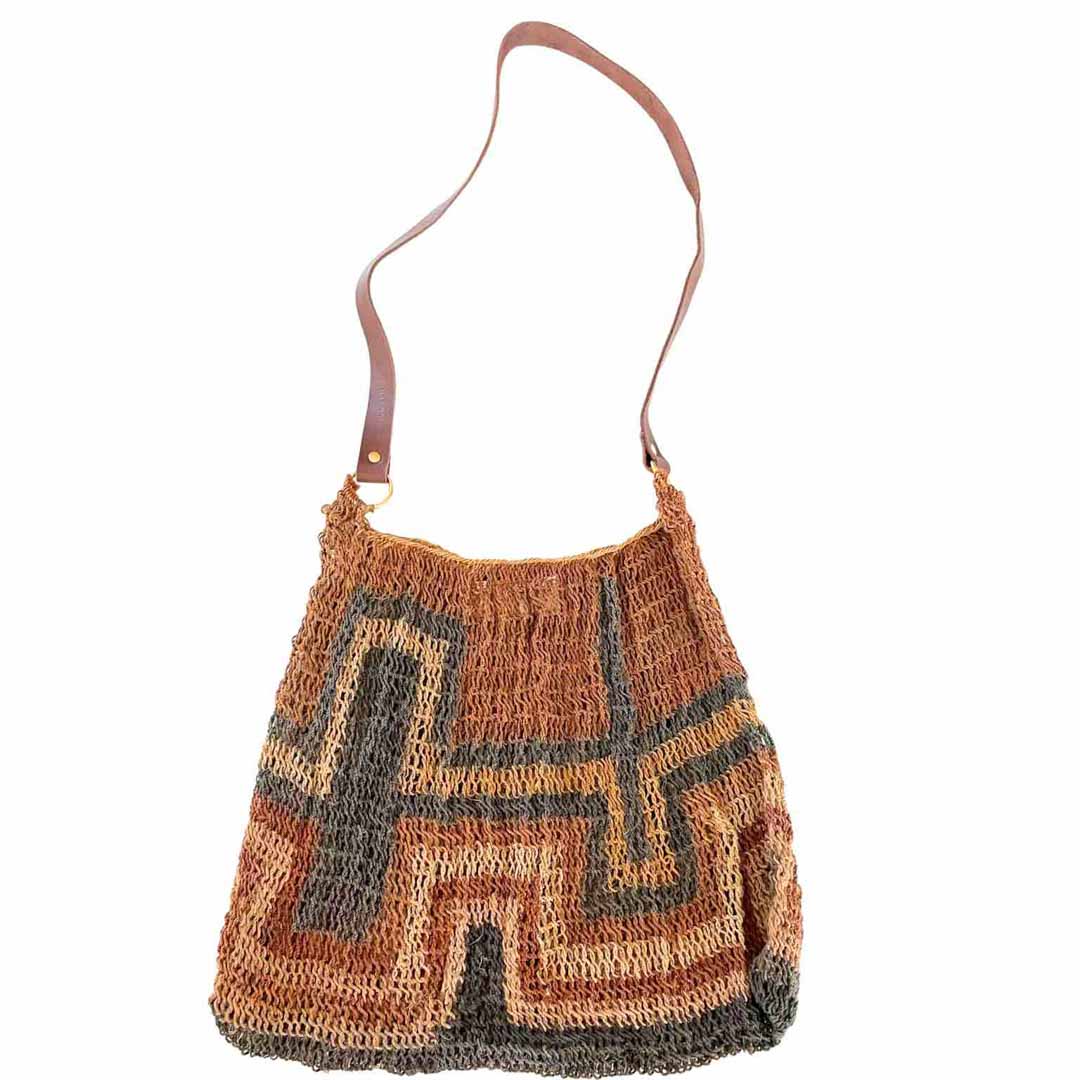 Detail shot of a handwoven natural fibre bilum with leather strap.