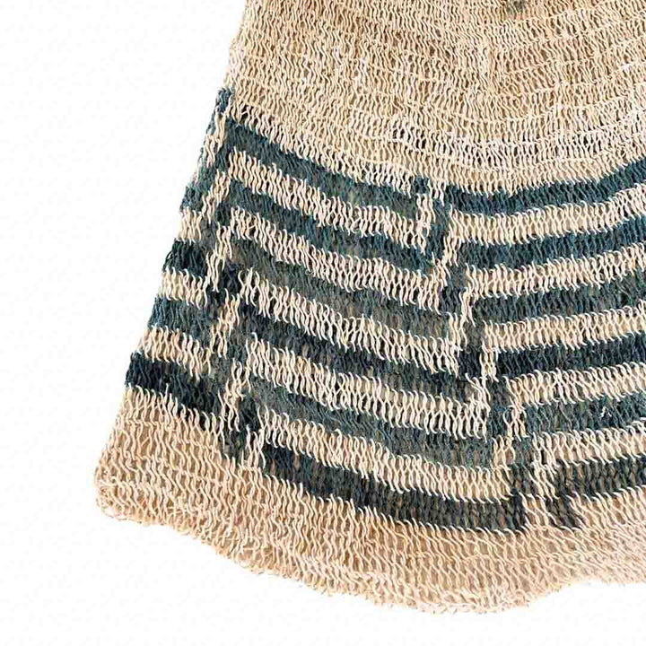 Close up on weave of a blue and white patterned natural fibre bilum.