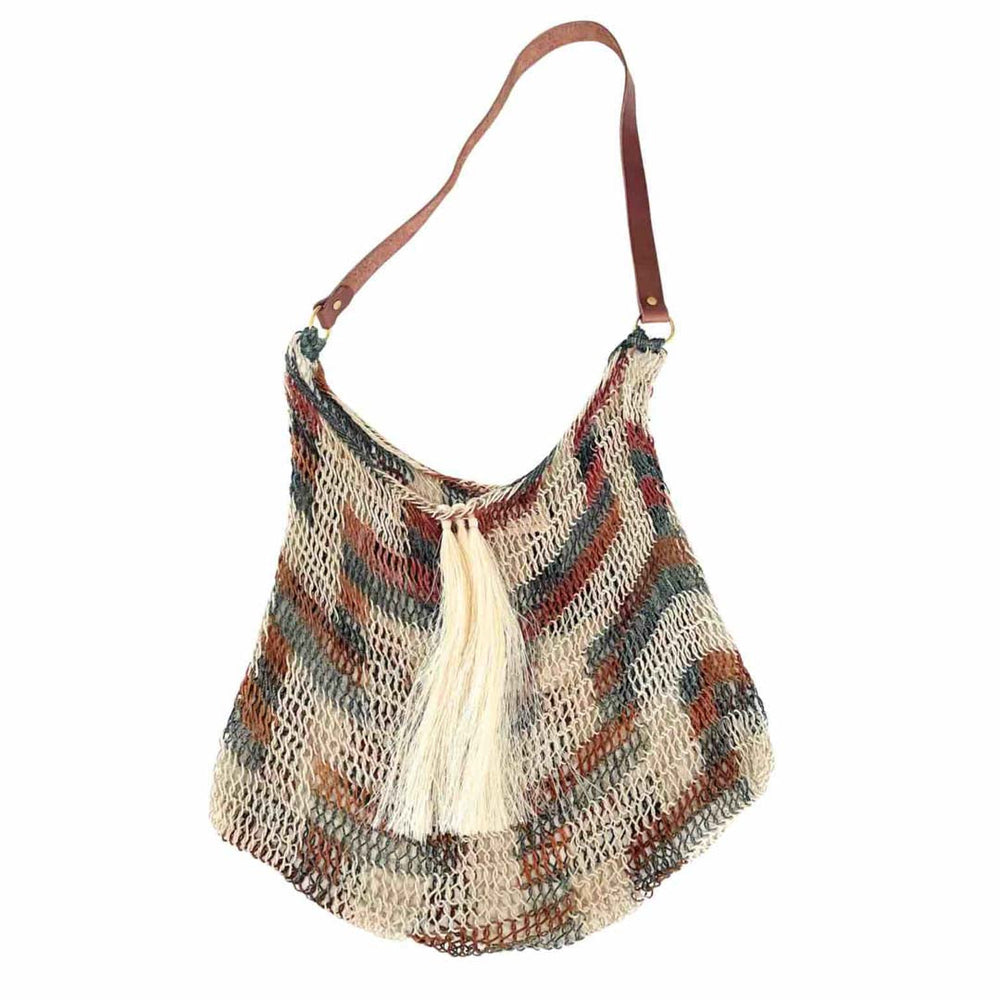 Natural bilum with tassels and a leather strap flat lay.