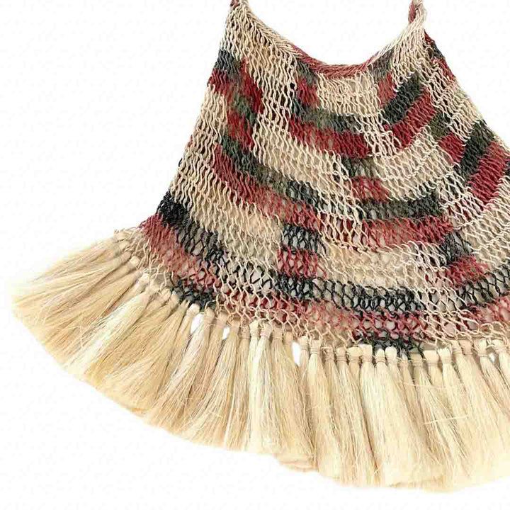 Corner detail shot of brown toned bilum with fringing.