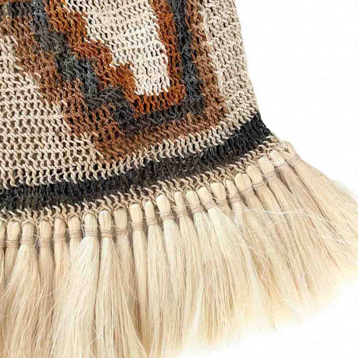 Close up on the fringing of a traditionally patterned bilum with fringing