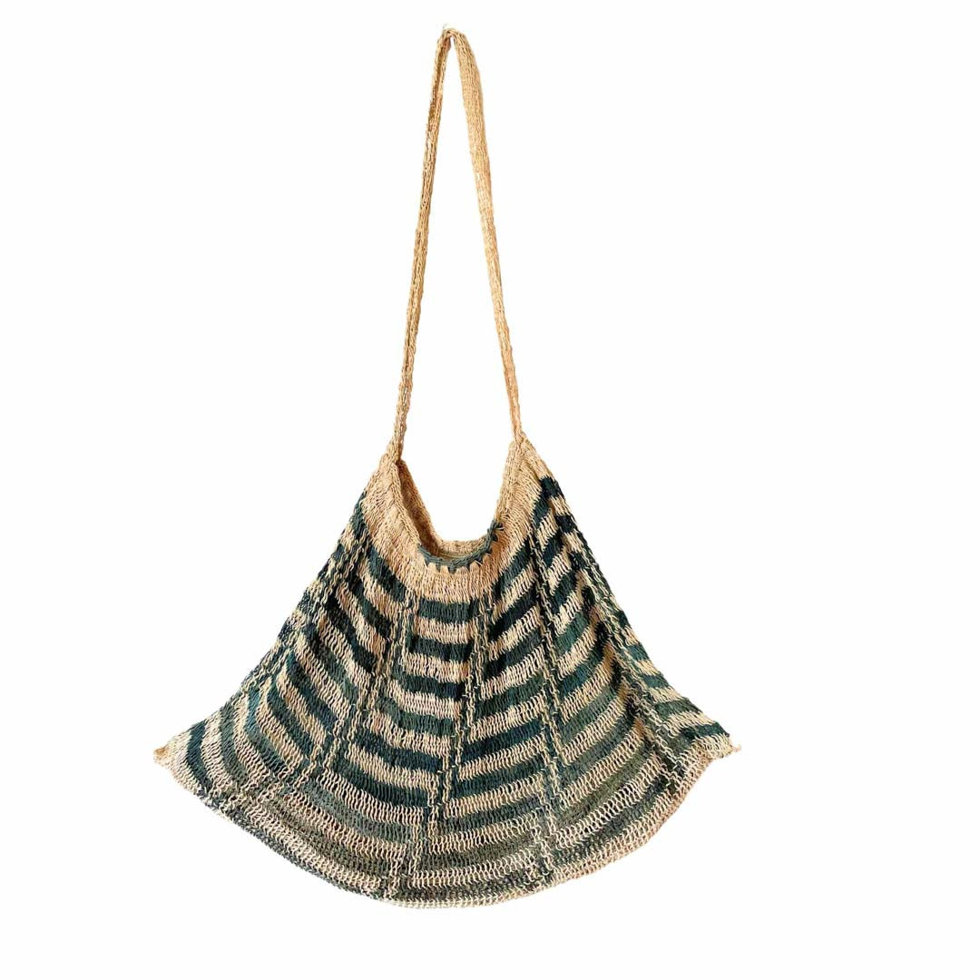Blue and white natural bilum hanging on a white background.