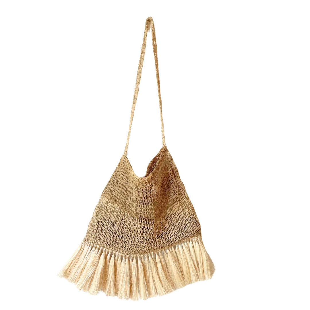 Plain natural fibre bilum with fringing hanging on a white background.