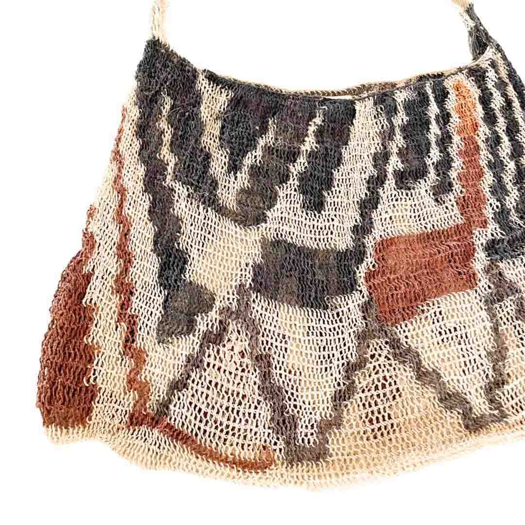 Close up on weave of natural fibre earth tone patterned blum.