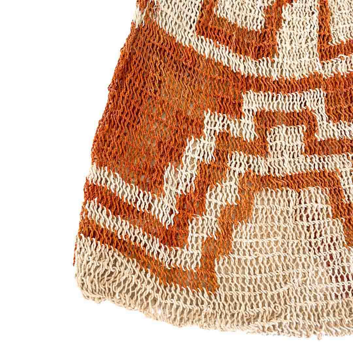 Corner close up of orange patterned bilum.