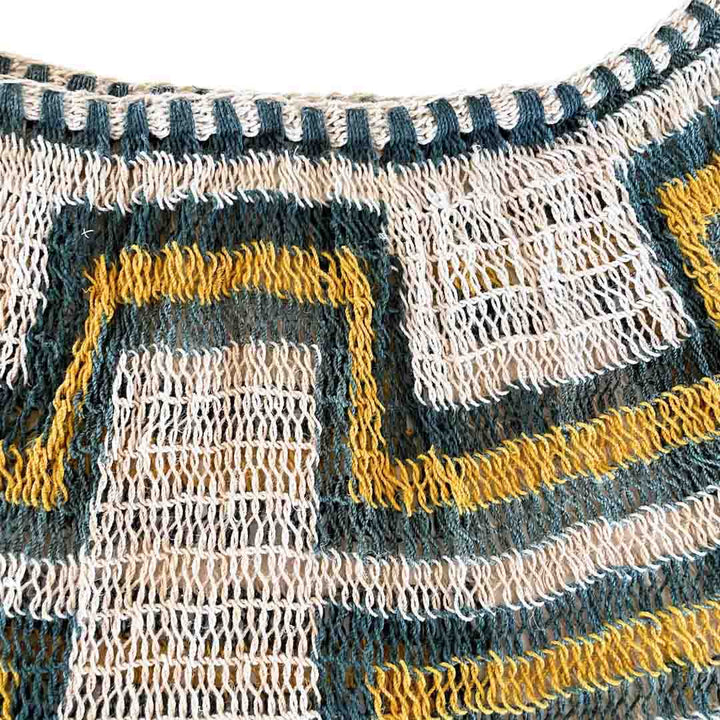 Opening of green and yellow patterned bilum.