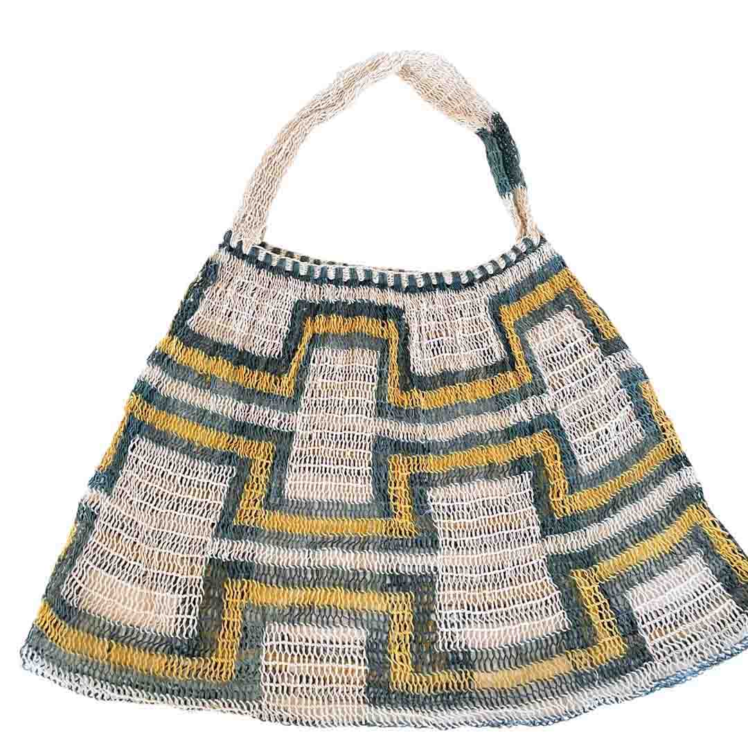 Flat lay of green and yellow patterned  natural fibre bilum.