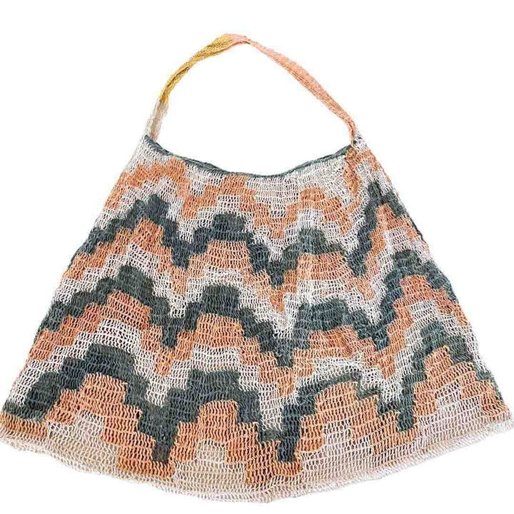Flat lay of pink and green patterned natural fibre bilum.