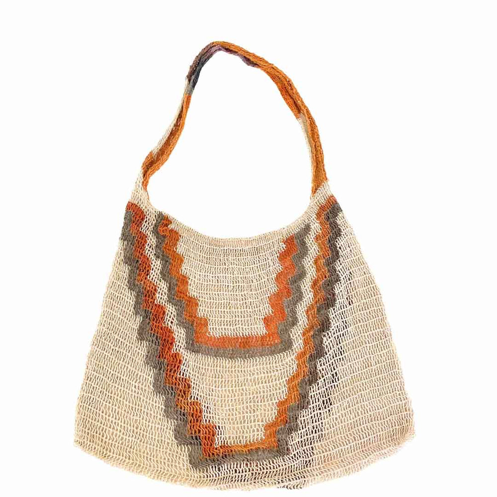 Flat lay of front of triangle patterned bilum hanging on a white background.