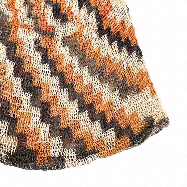 Corner close up of stripy patterned natural fibre bilum.