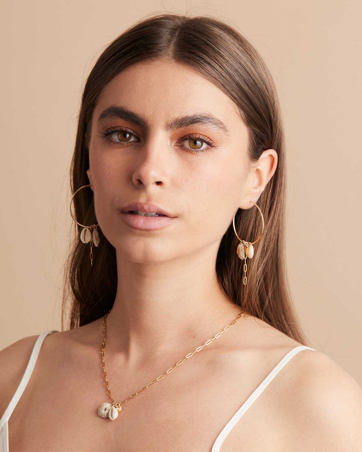 Modeal posing in Bilum and Bilas Gold filled Hoop Earrings with pacific charms