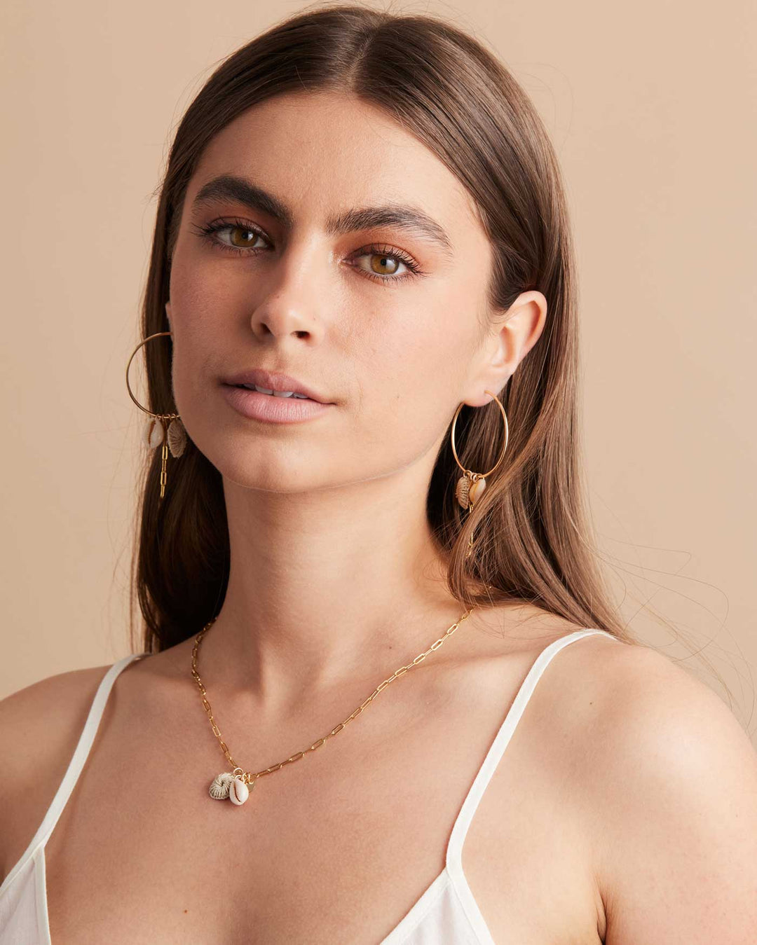Model wearing Bilum and Bilas gold filled paperclip chain necklace with pacific charms