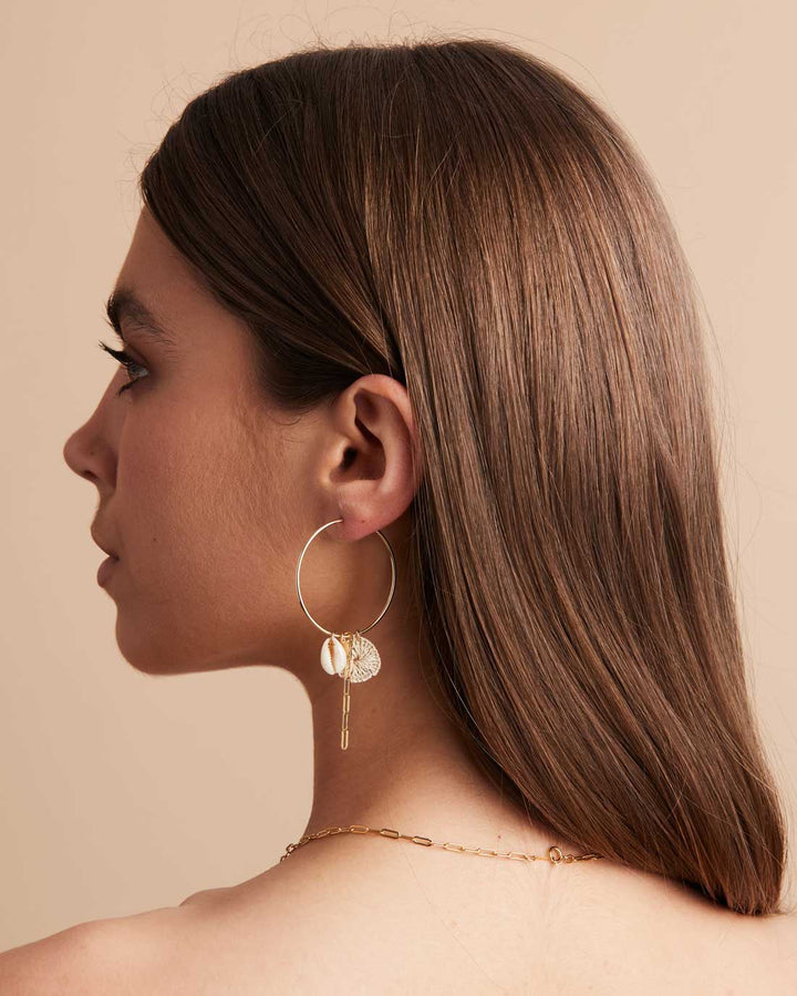 Model side profile wearing the Bilum and Bilas Gold filled Hoop Earrings with pacific charms angle view