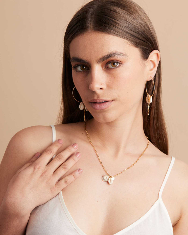 Model looking wearing Bilum and Bilas gold filled paperclip chain necklace with pacific charms