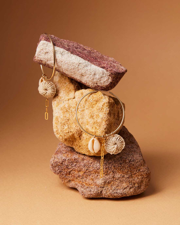Bilum and Bilas Gold filled Hoop Earrings with pacific charms still life on rocks
