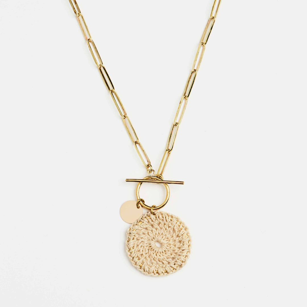 Close up of Bilum and Bilas brass gold Totem Link toggle Charm fastening and pendant