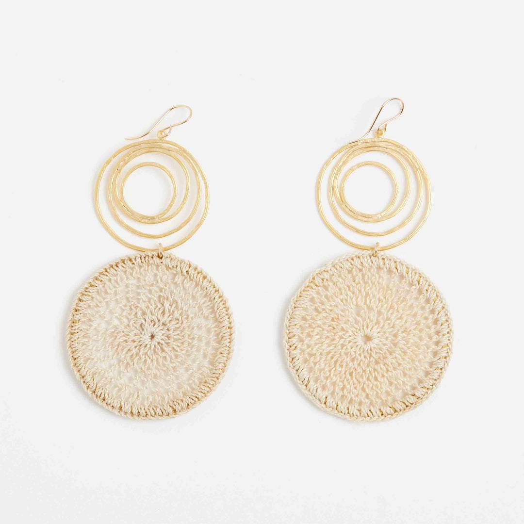 Gold swirl earrings with natural fibre woven disc front view