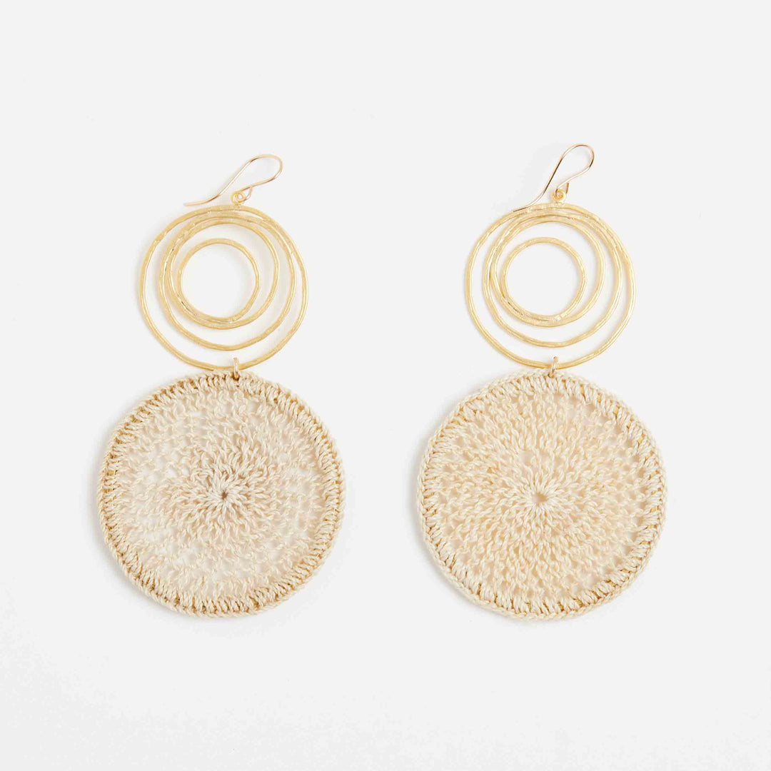 Gold swirl earrings with natural fibre woven disc front view