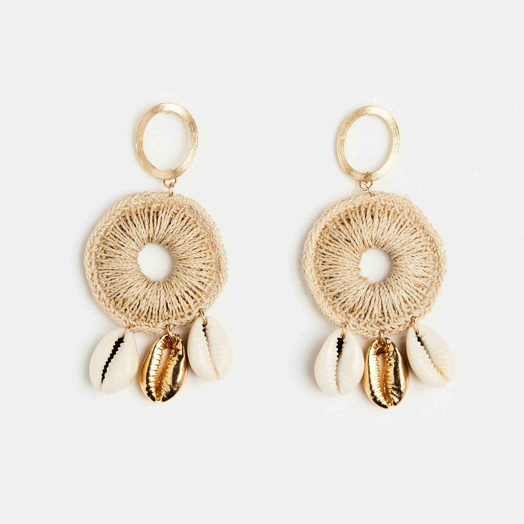 Dangle statement gold earring with handwoven hoop featuring natural and gold cowry shells