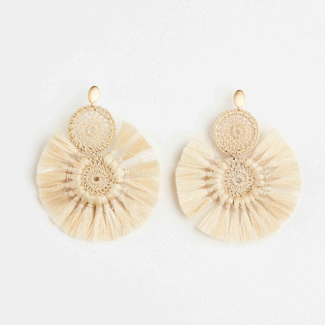 Bilum and Bilas Sandei statement earring front view. Double woven disc with natural fibre tassels.