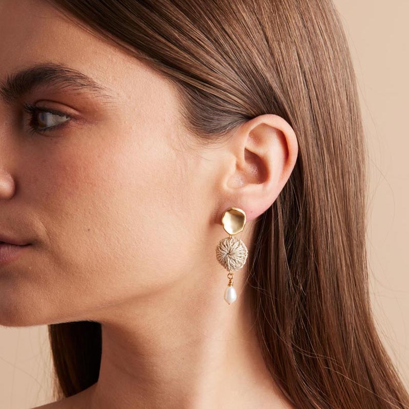 Lik Lik Malalo Earrings with pearl and natural fibre profile on model