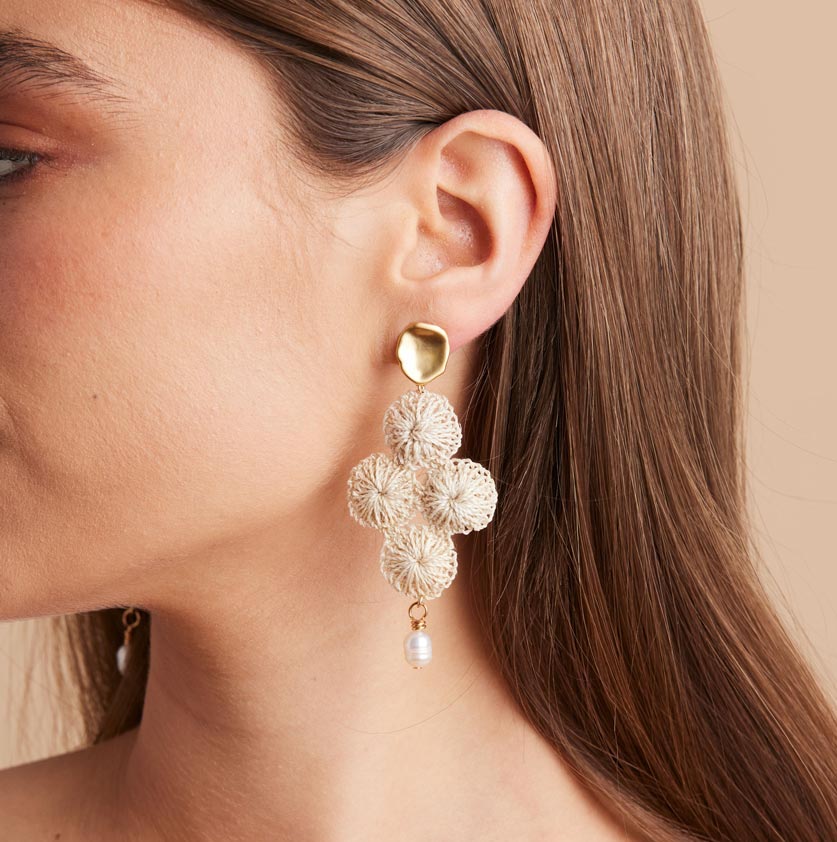Gold Malalo Breeze earrings with pearl and natural fibre profile on model