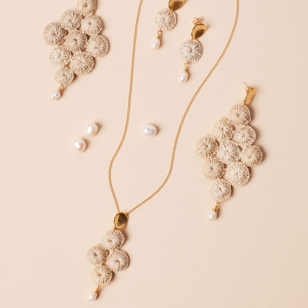 Silver and pearl with woven natural fibre statement Malalo Chandelier earrings flat lay collection