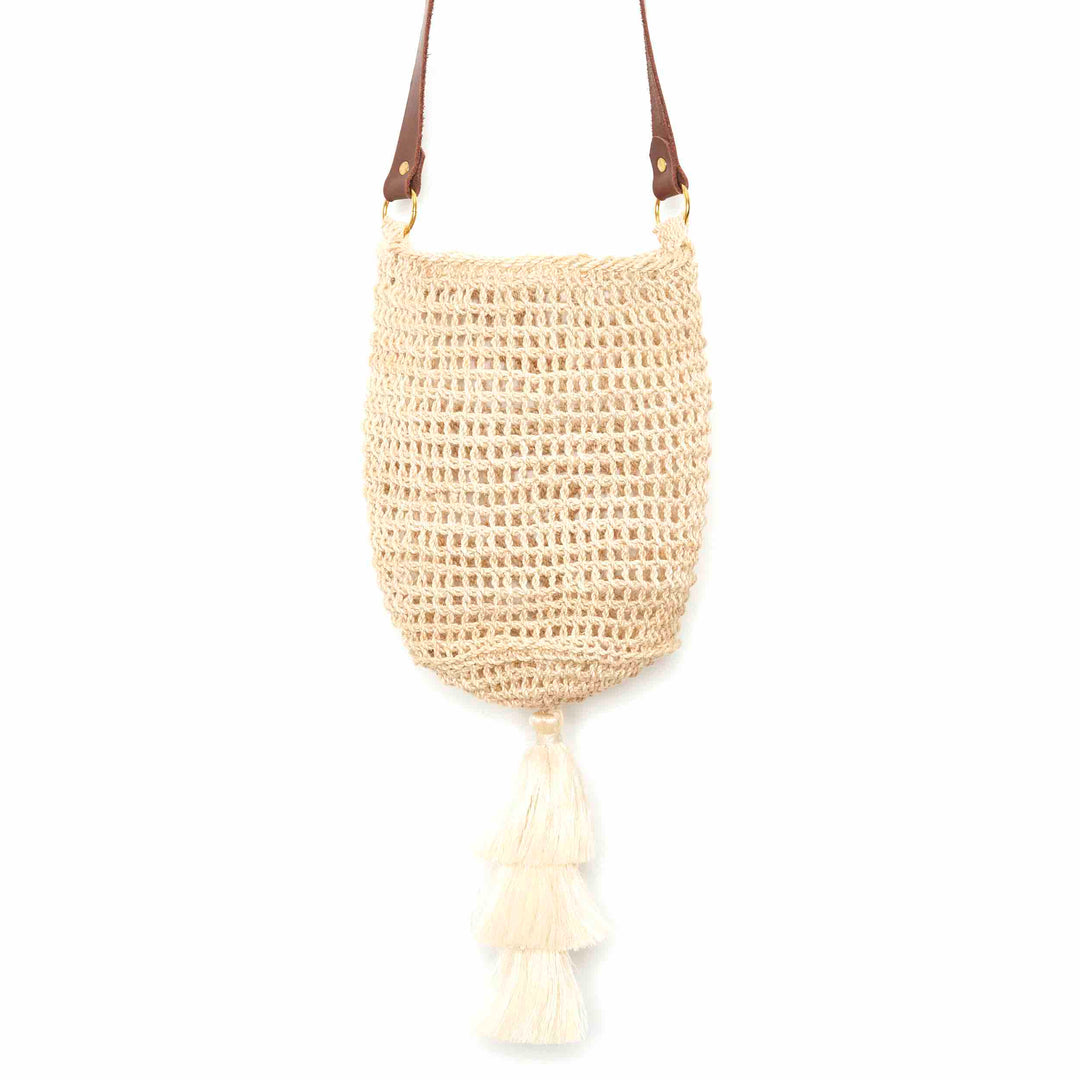 Close up of a natural fibre woven bucket bag.