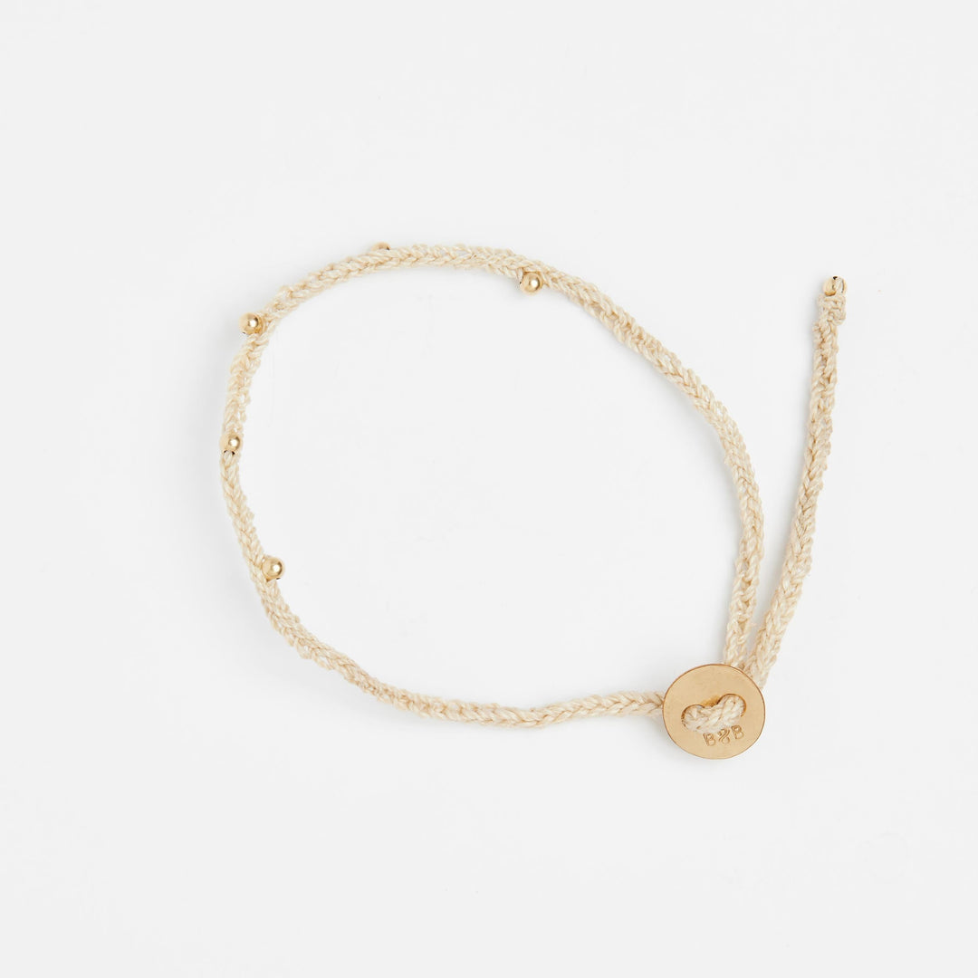 Natural fibre woven bracelet with gold beading details