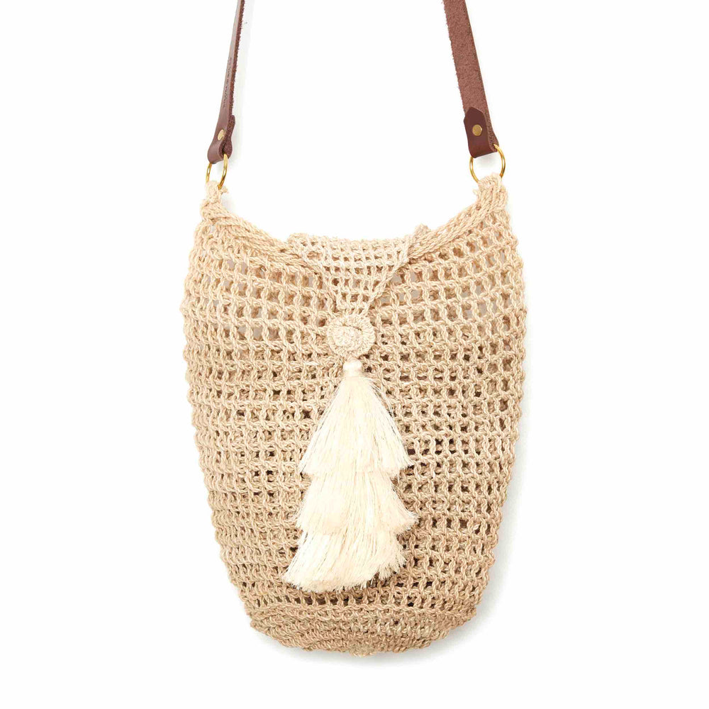 Close up of natural fibre bucket bilum with lid close and tassel hanging on a white background.
